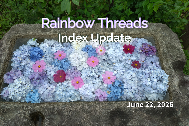 A stone water basin filled with floating hydrangea blossoms in soft shades of blue, white, and lavender, accented by pink and deep magenta cosmos flowers. Surrounded by greenery, the arrangement creates a peaceful early-summer atmosphere. Text overlay reads “Rainbow Threads – Index Update” with the date June 22, 2026.