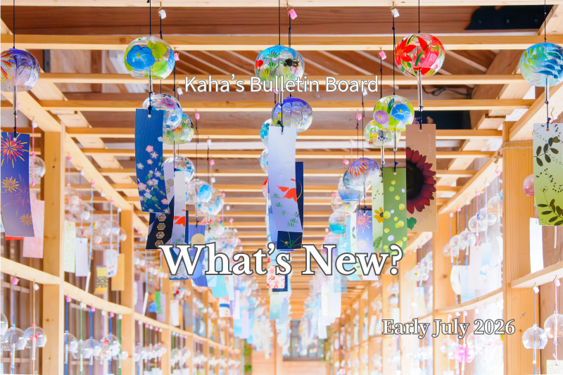 Rows of colorful Japanese glass wind chimes hanging beneath a wooden corridor, creating a bright summer atmosphere. The image is used as the featured banner for "What's New? – Early July 2026" on Rainbow Awakening, introducing the latest articles, videos, and seasonal updates from Japan.